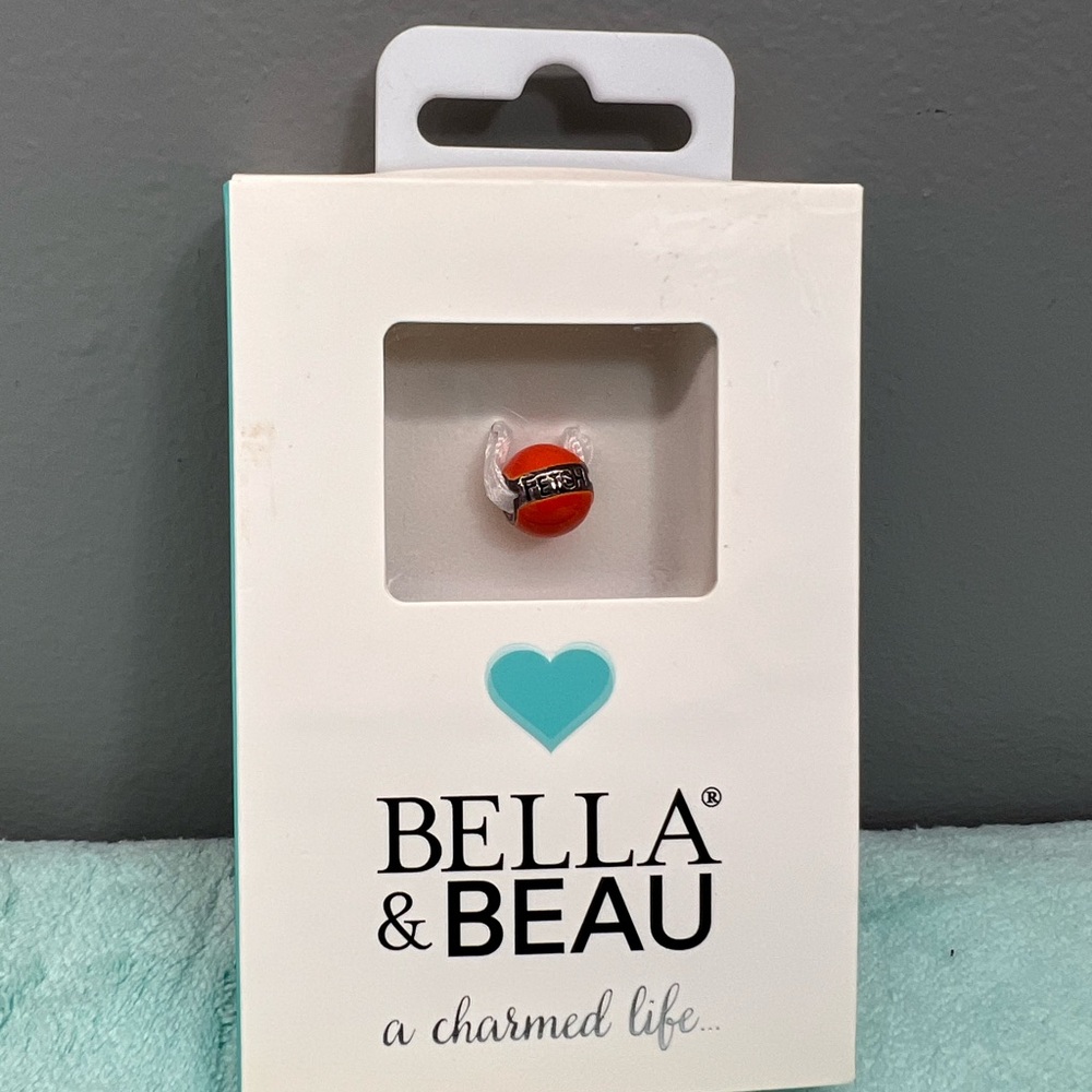 Bella and Beau red ball that says Fetch